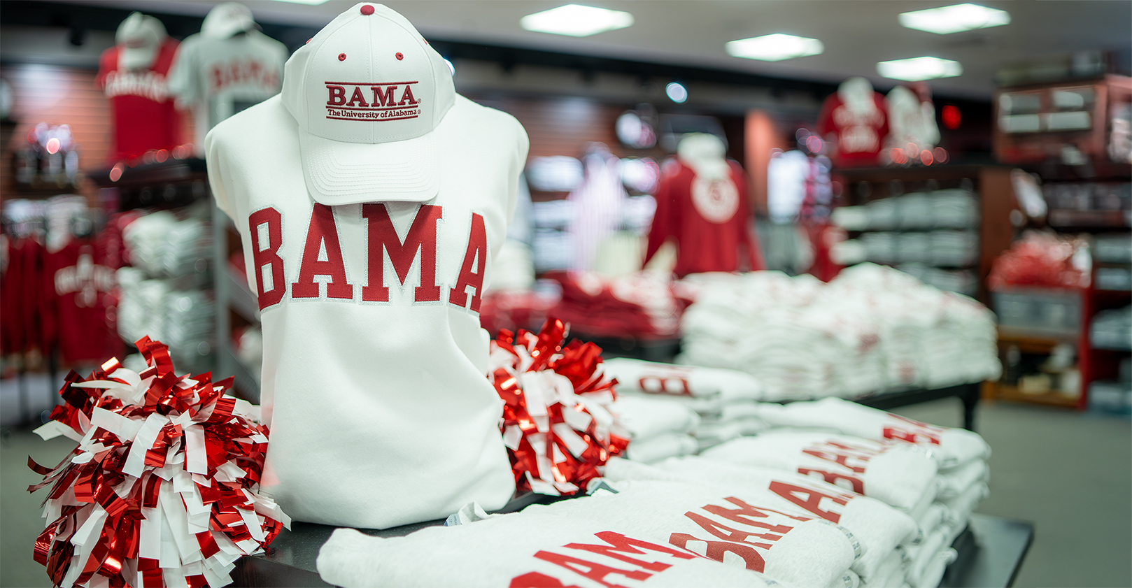 Bama apparel for the whole family, picturing a white crew neck BAMA sweatshirt.
